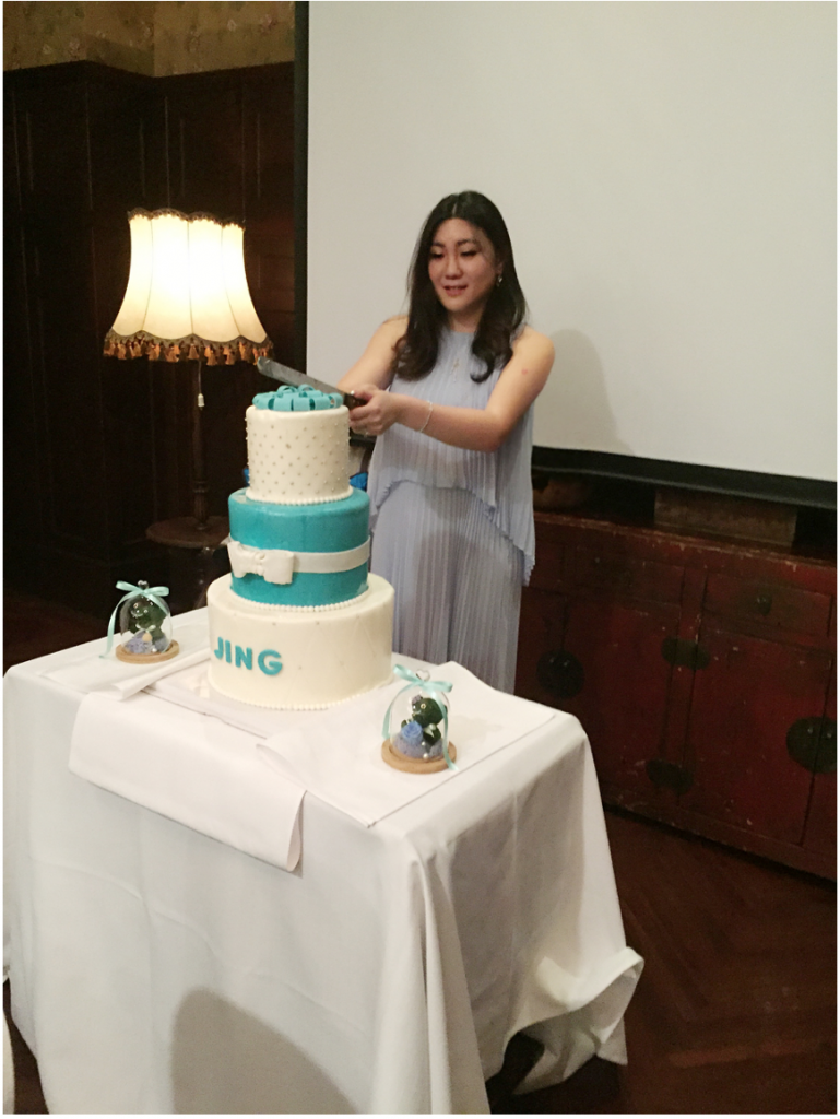 Jennifer cutting the cake at the press release for her new book.